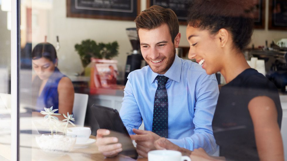 Professionals looking at a tablet.