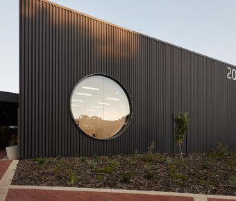 An exterior photo of building 202 with modern round window