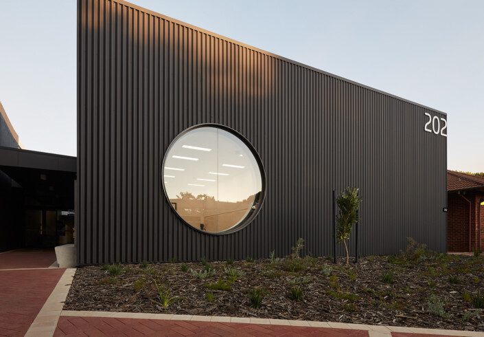 An exterior photo of building 202 with modern round window
