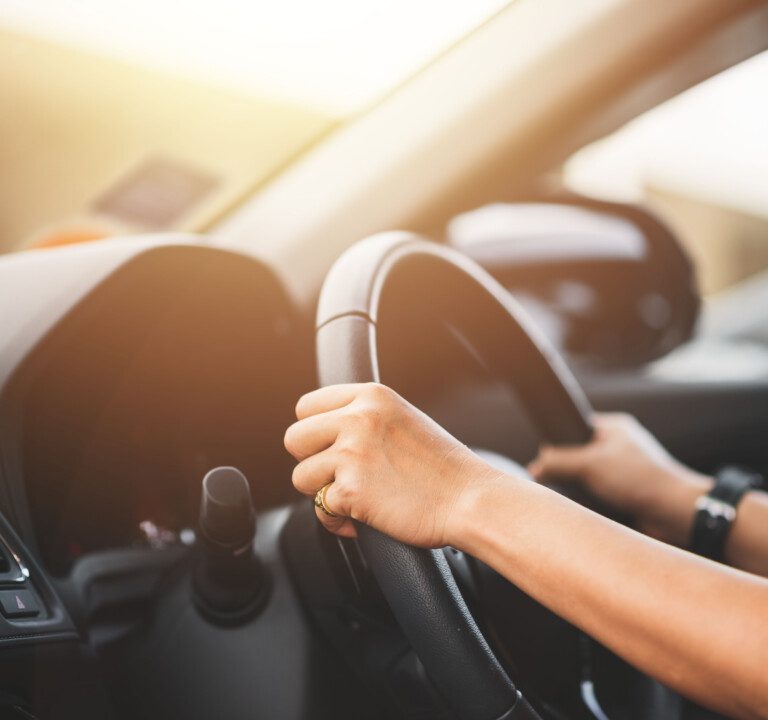 Close Up of Woman Driving a Car on Road - Transportation Concept