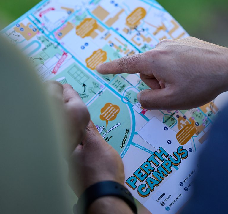 A student points to a point on the Hidden Treasures map for Perth Campus.